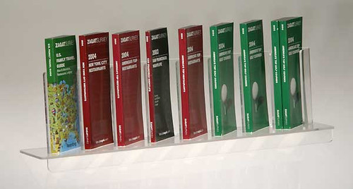 Clear acrylic eight pocket shelf insert sized for DVDs, brochures, paperback books, etc.