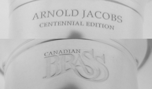 This beautiful Arnold Jacobs Centennial Tuba Mouthpiece comes in both Gold and Silver Plate finishes with "Arnold Jacobs Centennial Edition" on one side and the Canadian Brass logo on the other. This beautiful Arnold Jacobs Centennial Tuba Mouthpiece comes in both Gold and Silver Plate finishes with "Arnold Jacobs Centennial Edition" on one side and the Canadian Brass logo on the other.