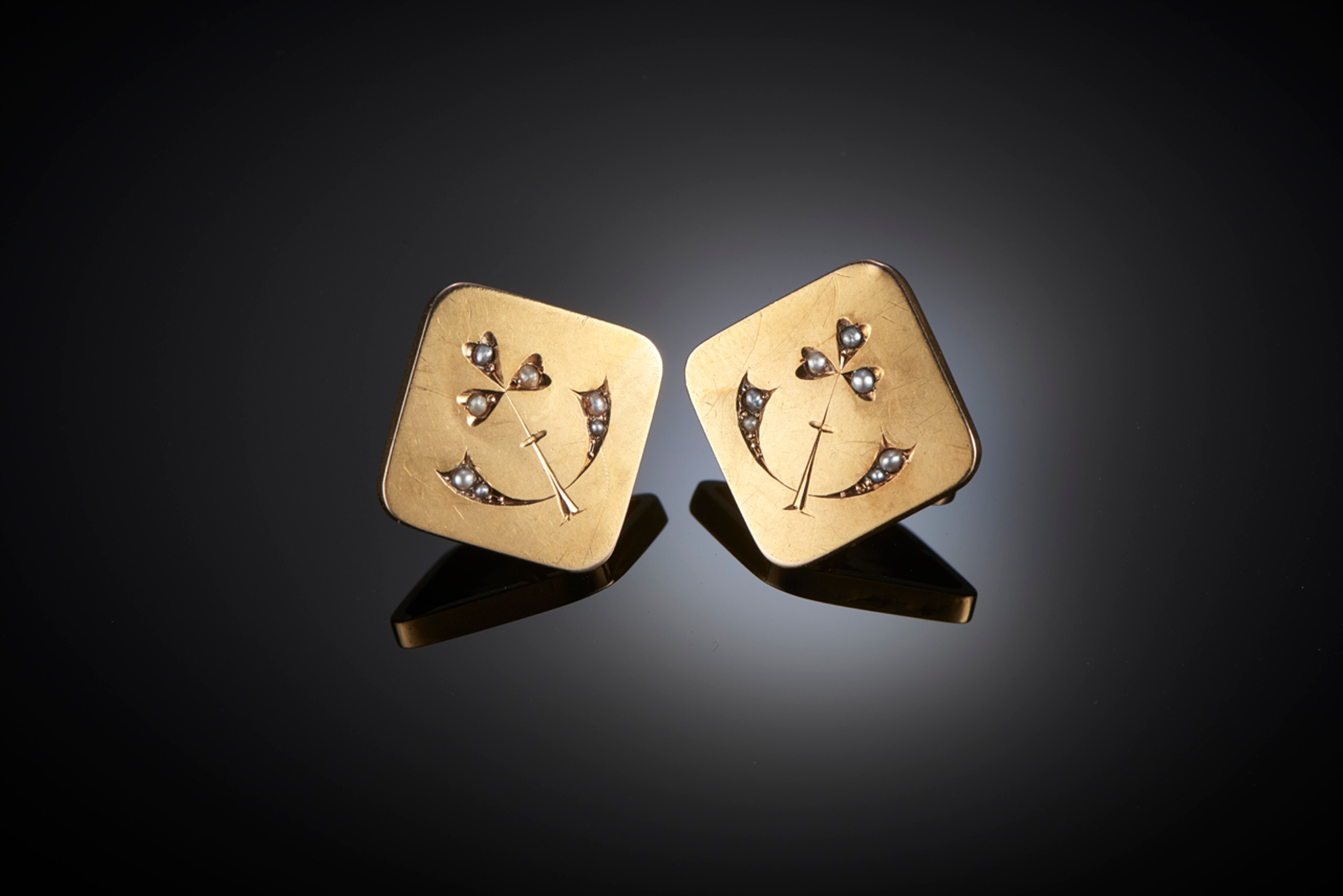 Gold Art Nouveau Cufflinks.
In a square design with rounded edges, each set with seven seed pearls in stylised foliate form.
18ct yellow gold.
French.