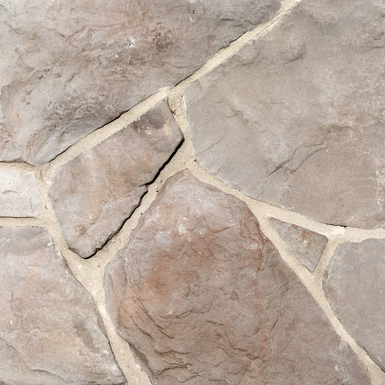 Photo of Summit Colorway Fieldstone Stone Veneer samples from Superior Stone MFG with a lighter tan grout.