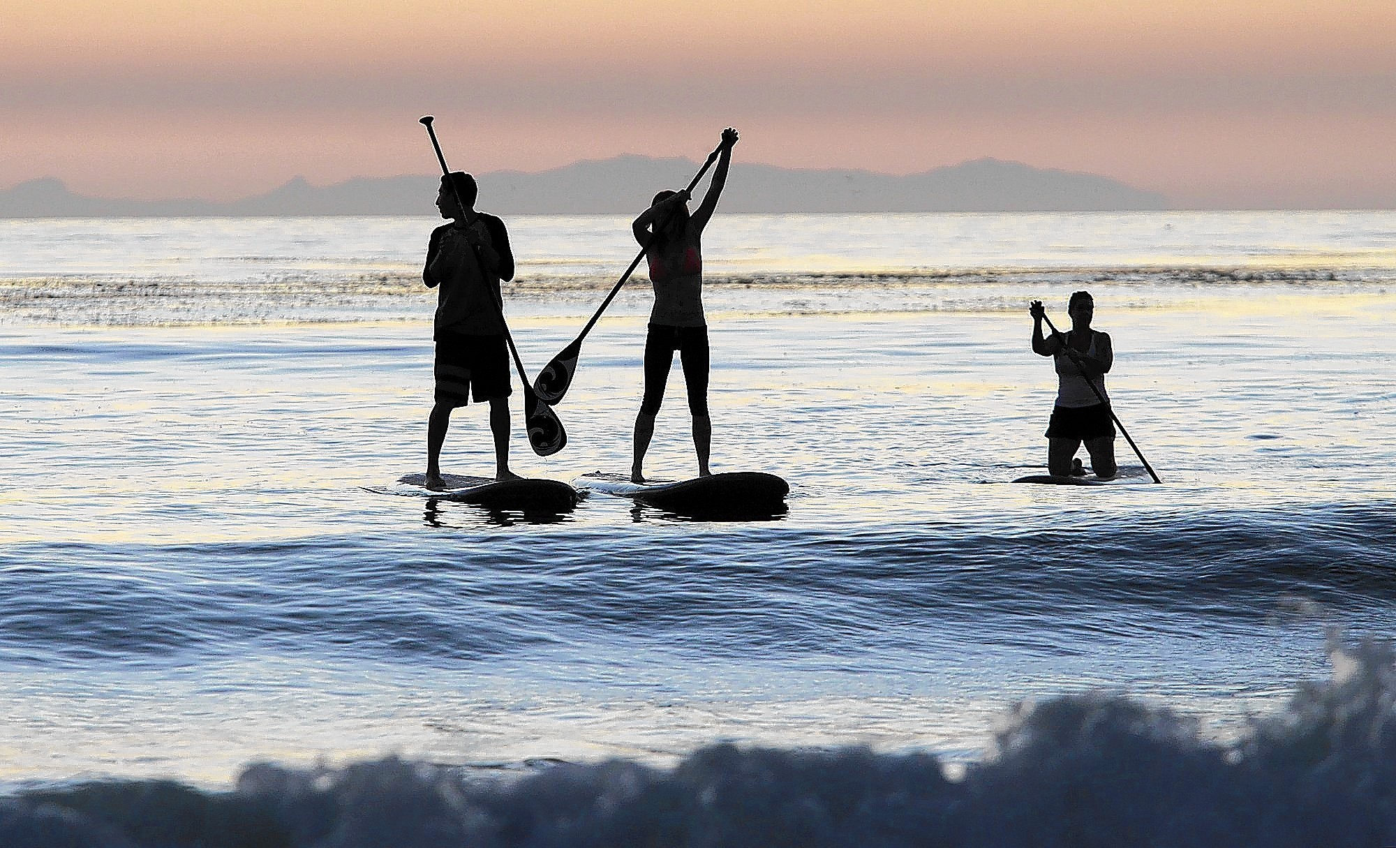 Paddle boarding Orange County at sunset