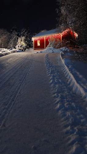 Lighted Red Christmas Cabin at Night