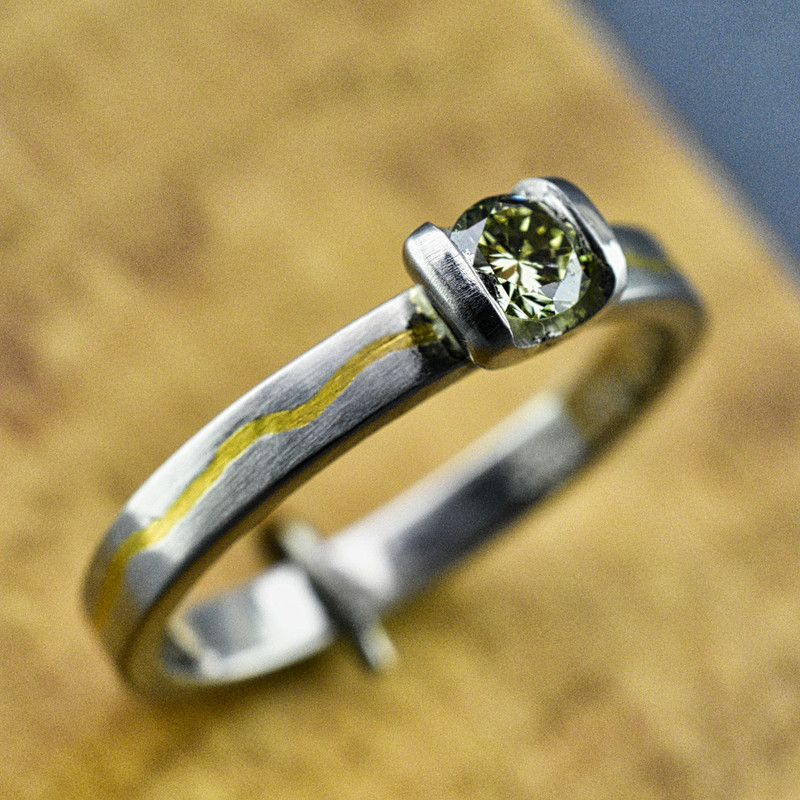 .950 Platinum Band Inlaid with 24K Gold and a .23 CT Green Diamond