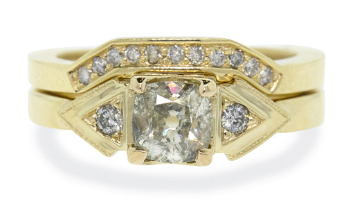 .85 carat Champagne Diamond, cushion cut engagement ring with shadow wedding band stacked with it. Set is made in 14k recycled yellow gold. Gray diamonds on the shoulders and in the wedding band. Geometric design with art deco style. Front view on white background.