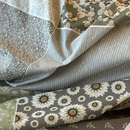 assortment of cotton quilt fabrics