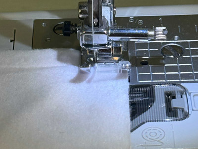Sewing the fleece blanket around the edges