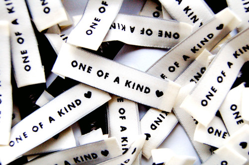 One of a Kind sew-in fabric label for clothing.