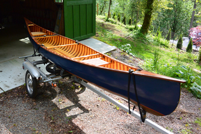 Blue wood and canvas canoe with Danuu cover