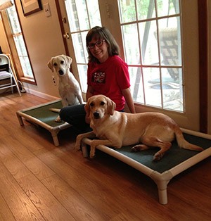 Rachel Thornton posing with two dogs on Kuranda Beds