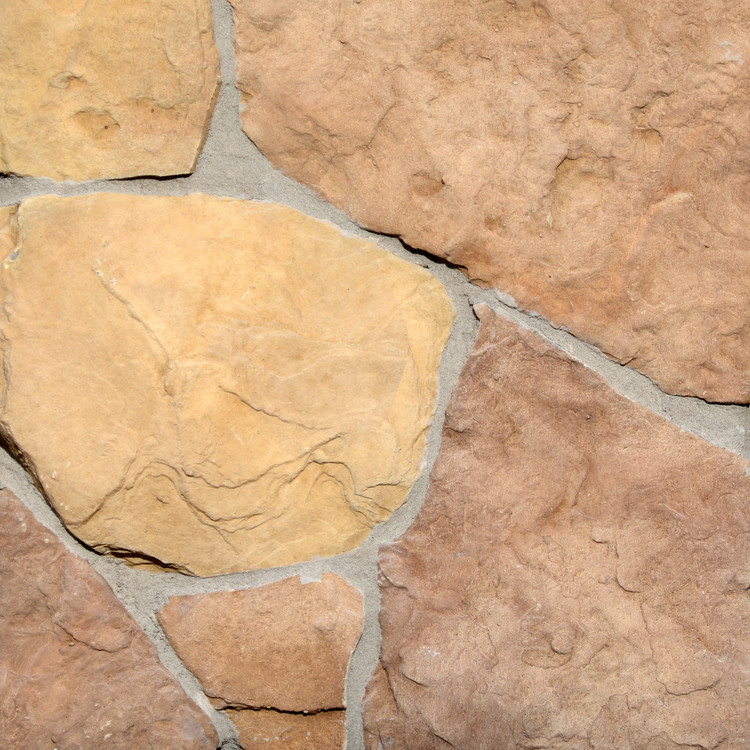 Photograph of Washington based Superior Stone MFG's Fieldstone stone siding in the Cascade colorway. Shown with a lighter grey grout.
